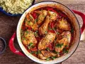 Un plat mijoté de poulet basquaise de ma grand-mère, avec des morceaux de poulet dorés, des poivrons et une sauce tomate savoureuse, garni de persil frais.