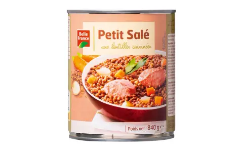 Boîte de petit salé aux lentilles cuisinées, avec des morceaux de viande, des carottes et des dés de légumes.