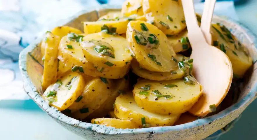 Salade de pommes de terre aux herbes fraîches, nappée d'une vinaigrette savoureuse. Un délice pour accompagner vos repas.